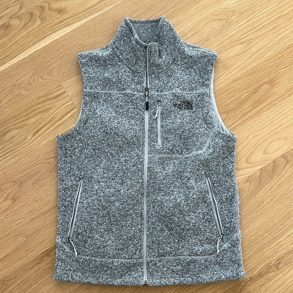 Grey North Face zip-up vest with multiple pockets (size M)